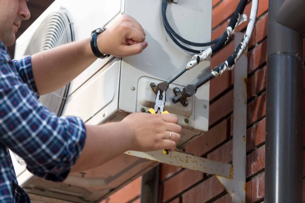 closeup of male technician repairing outdoor air c 2021 12 09 17 34 31 utc