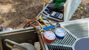 Close-up of HVAC pressure gauges connected to an outdoor air conditioning unit, showcasing the precision tools vital for commercial HVAC services in Mississauga, Heating maintenance, HVAC Maintenance