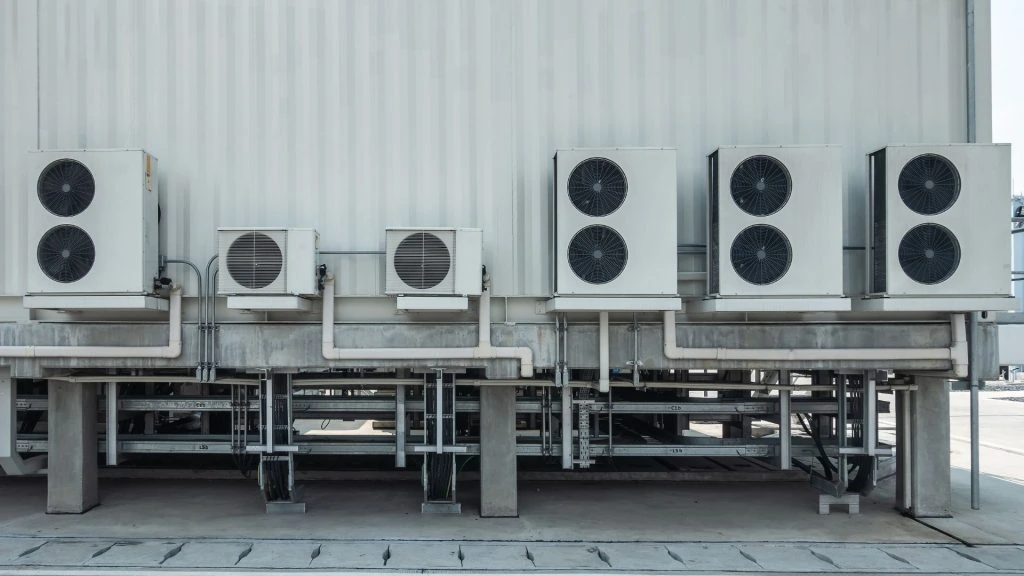 A row of industrial air conditioning units is mounted on the building exterior, showcasing Mississauga's expertise in HVAC solutions and furnace repair.