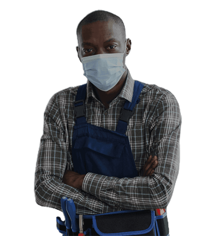 A man in a plaid shirt and blue overalls stands with arms crossed, wearing a mask. An HVAC contractor, he carries tools in a belt at his waist, ready to tackle any heating or cooling challenge.
