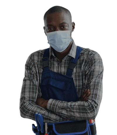 A man in a plaid shirt and blue overalls stands with arms crossed, wearing a mask. An HVAC contractor, he carries tools in a belt at his waist, ready to tackle any heating or cooling challenge.